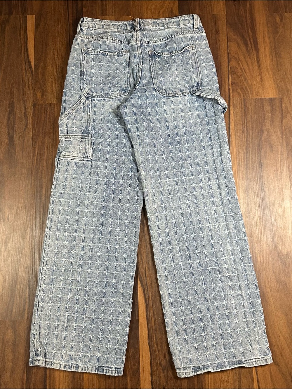 Forever 21 carpenter denim jeans with repeating distressed pattern.